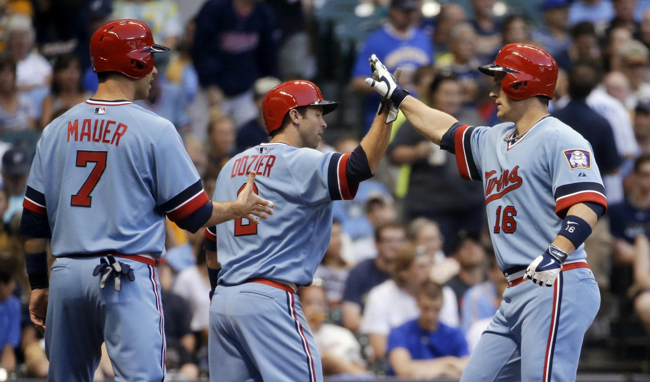 Minnesota Twins' Josh Willingham (16) is congratulated by Joe Mauer (7) and Brian Dozier (2) after hitting a three-run home run during the third inning of a baseball game against the Milwaukee Brewers on Tuesday, June 3, 2014, in Milwaukee.