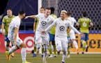 Minnesota United' Emanuel Reynoso, right, celebrates his goal against the Seattle Sounders with teammates Michael Boxall, left, and Jan Gregus during 