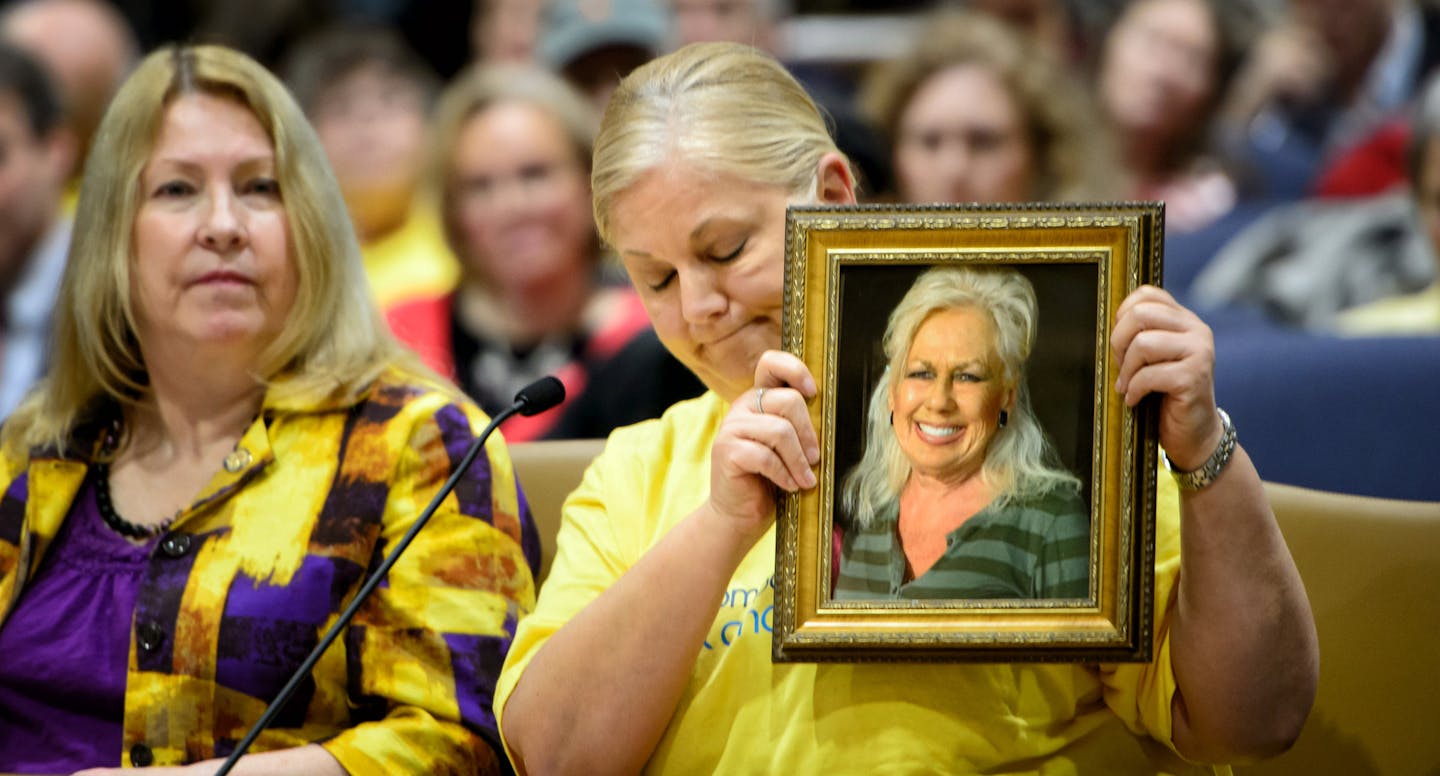 Sally Settle held a photo of her mom, who died in pain from leukemia. Sen. Chris Eaton, left, sponsored the Compassionate Care Act.