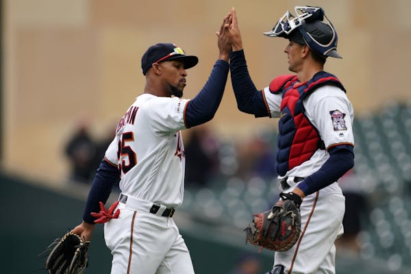 Minnesota Twins center fielder Byron Buxton (25) celebrated the win with Minnesota Twins catcher Jason Castro (15) at the end of the game Thursday.