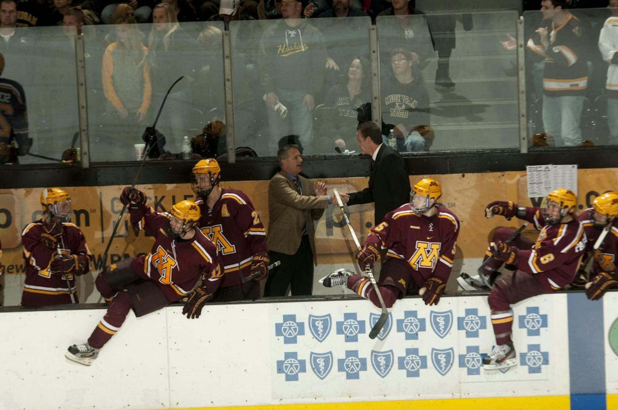 Gophers coach Don Lucia got a congratulatory handshake from Huskies coach Mel Pearson after notching his 600th career victory. The Gophers, led by Seth Ambroz's two goals, beat Tech 3-2 to split the series.