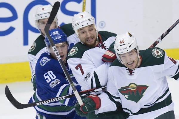 Minnesota Wild's Chris Stewart (7), Tyler Graovac (44) and Charlie Coyle, celebrated during Saturday's victory at Vancouver.