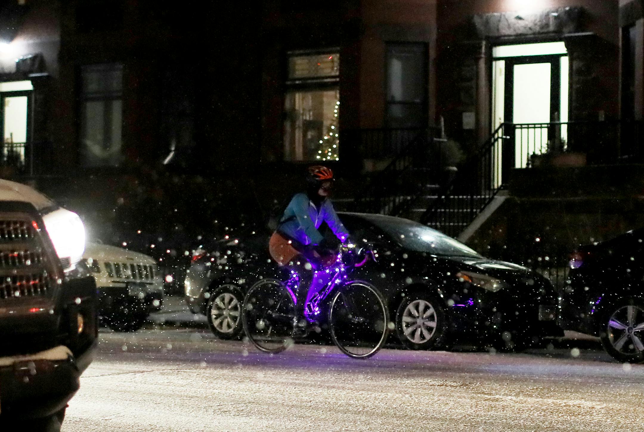 Amid falling snow during rush hour a bicyclist with purple lights adorning her bike makes her way along S. 9th St. in downtown Wednesday, Nov. 28, 2018, in Minneapolis, MN.] DAVID JOLES ï david.joles@startribune.com Minneapolis Fire Department crews erected a heated tent for meals and outreach services across from the large homeless encampment on Franklin and Hiawatha avenues. Officials said they hope the tent will serve as a meeting space for people living at the camp, and enable them to b