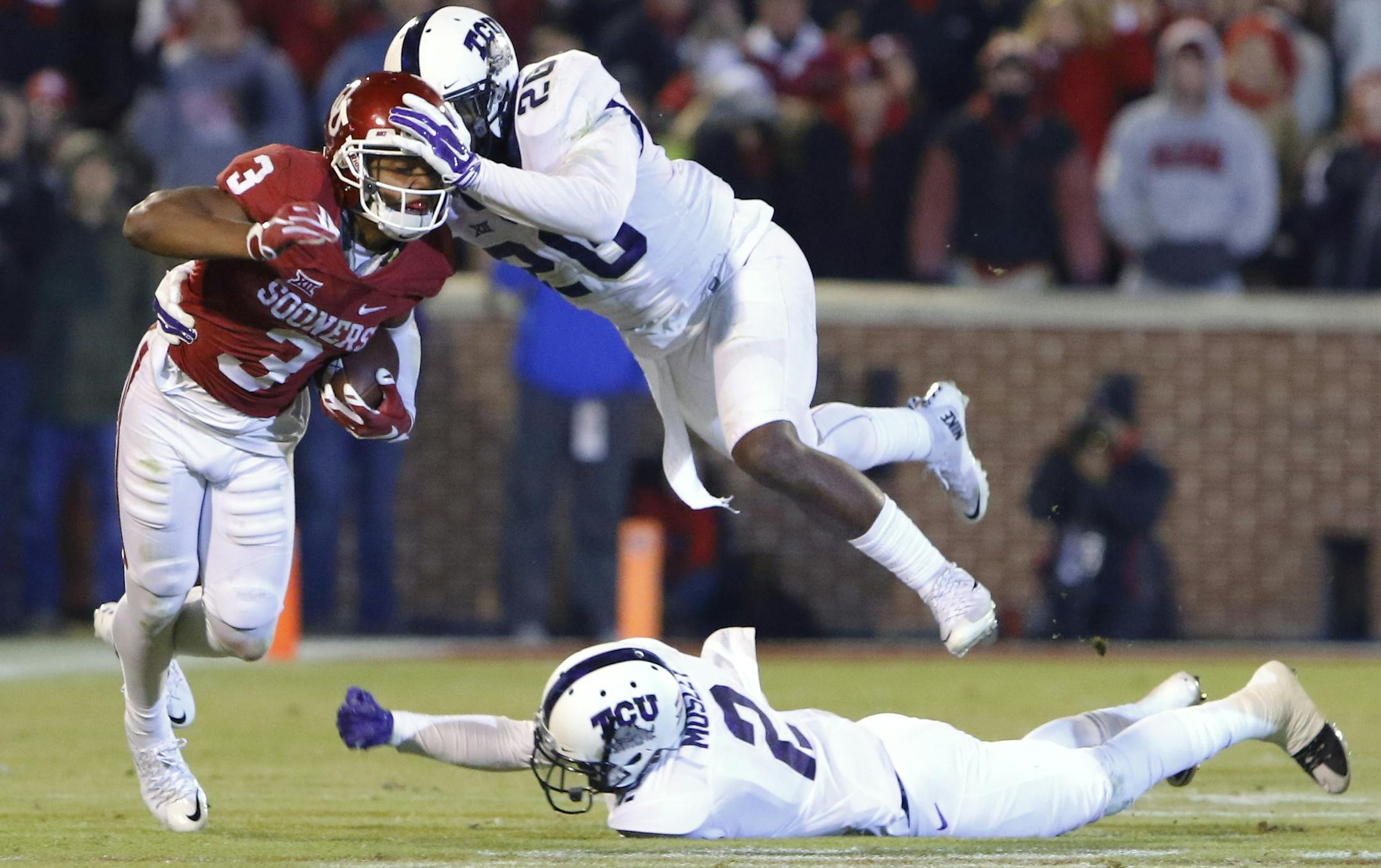 Oklahoma wide receiver Sterling Shepard (3) is tackled by TCU safety Derrick Kindred (26) during the third quarter of an NCAA college football game in Norman, Okla., Saturday, Nov. 21, 2015. Oklahoma won 30-29. (AP Photo/Alonzo Adams)