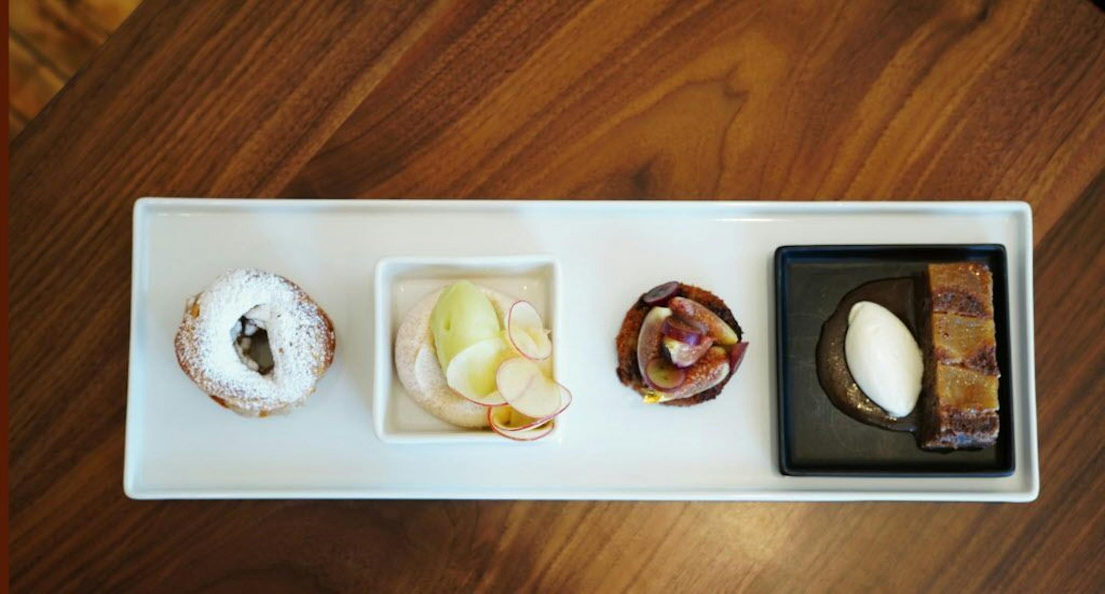 The fall tasting has apple pavlova, fig and grape with date cake, and pecan Paris-Brest.
