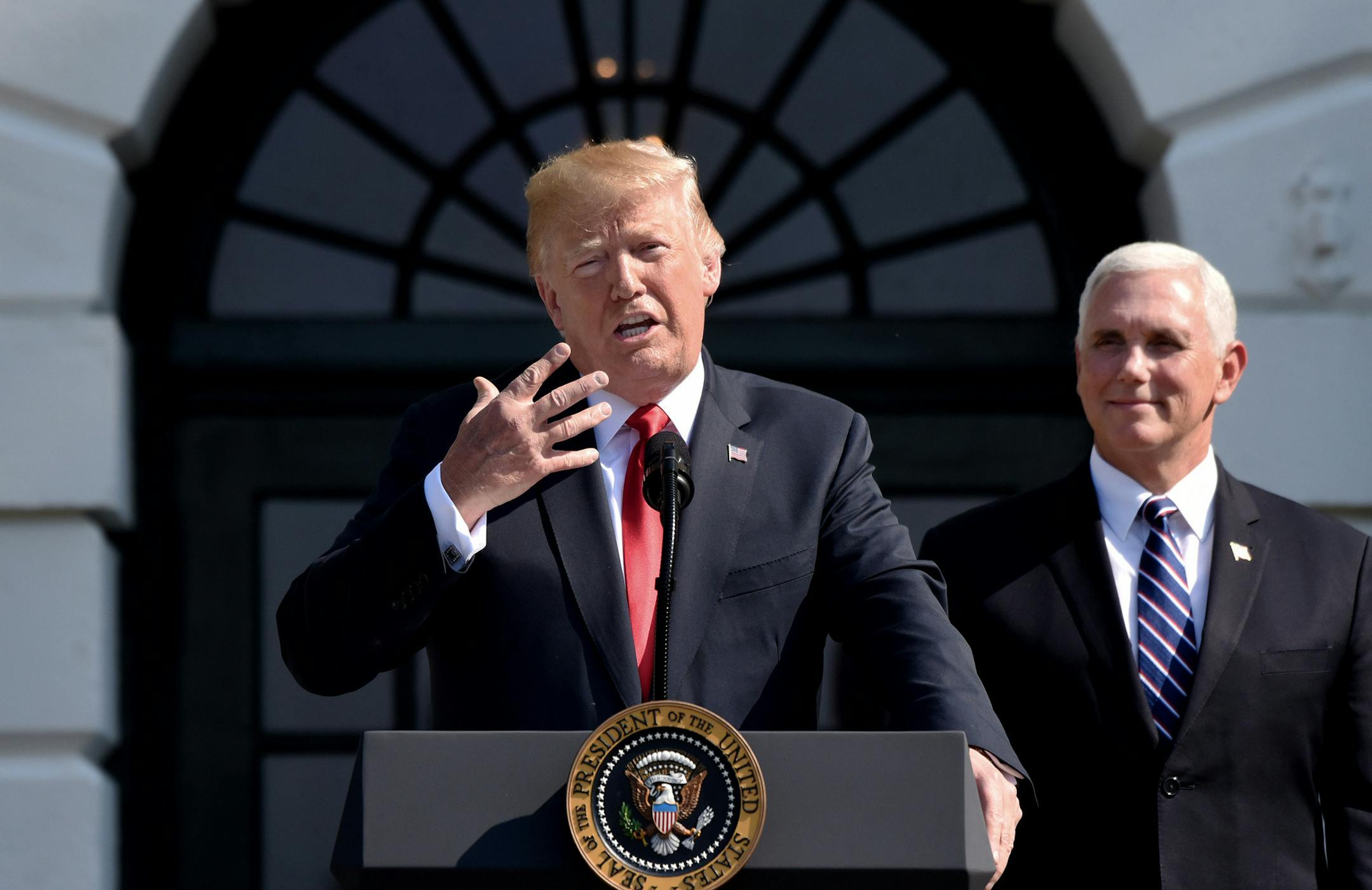 U.S. President Donald Trump comments on the 4.1 percent economic growth for the second quarter as Vice President Mike Pence looks on during a statement in the South Lawn of the White House July 27, 2018 in Washington, D.C. (Olivier Douliery/Abaca Press/TNS) ORG XMIT: 1236755
