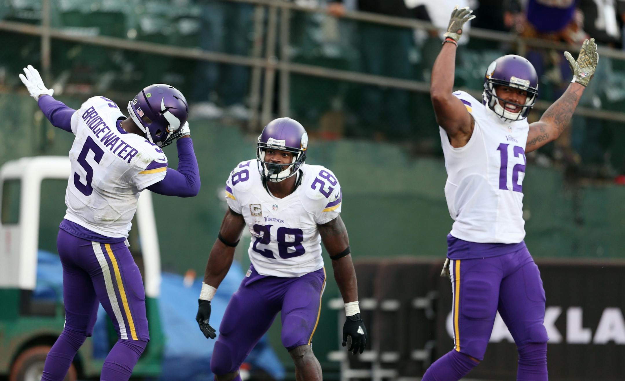 Minnesota Vikings running back Adrian Peterson (28) celebrated his 80 yard touchdown run in the fourth quarter with Teddy Bridgewater (5) and Charles Johnson (12).