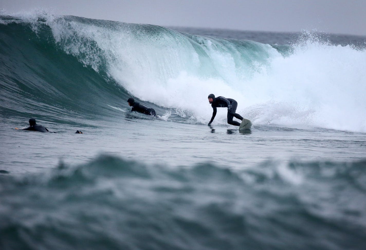 JD Johnson of Edina, who moved to Minnesota from Laguna Beach, Calif., about eight years ago to work at Target, rides a wave on Lake Superior near Stony Point Thursday, March 17, 2016, in Two Harbors.