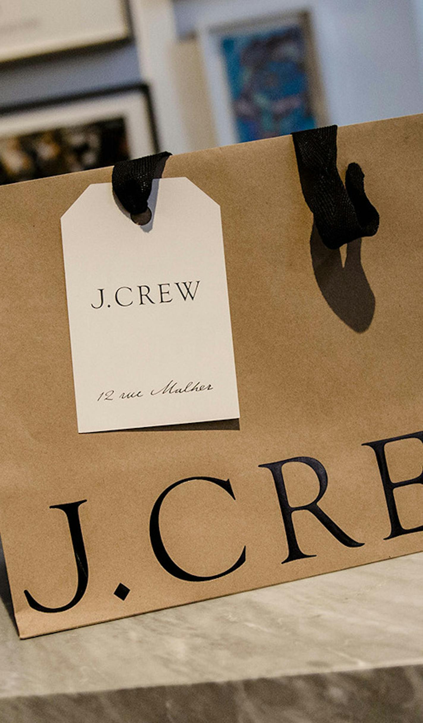 A J. Crew branded carrier bag sits on display inside a J. Crew Group Inc. fashion clothing store ahead of its official opening, in Paris, France, on Wednesday, March 4, 2015. J. Crew is increasingly looking overseas for growth, opening stores in London, Hong Kong, Canada and Paris and also expanding its offshoot Madewell brand. Photographer: Marlene Awaad/Bloomberg ORG XMIT: 541166113