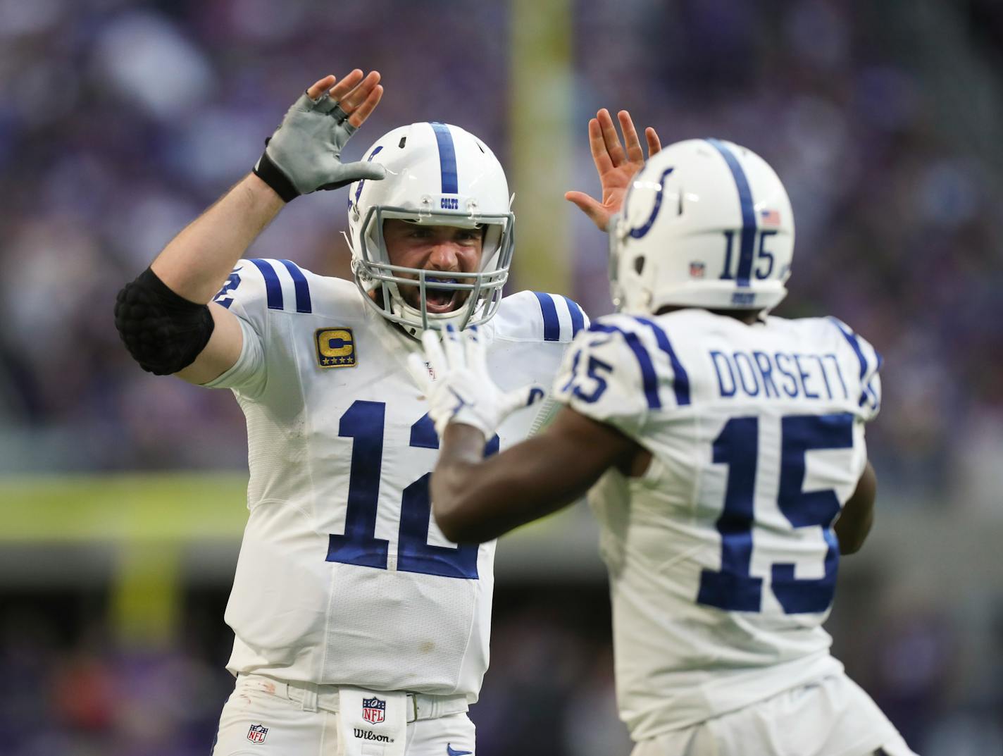 Colts quarterback Andrew Luck (12) celebrates with wide receiver Phillip Dorsett (15) after their 50-yard touchdown connection on the first play of the fourth quarter.