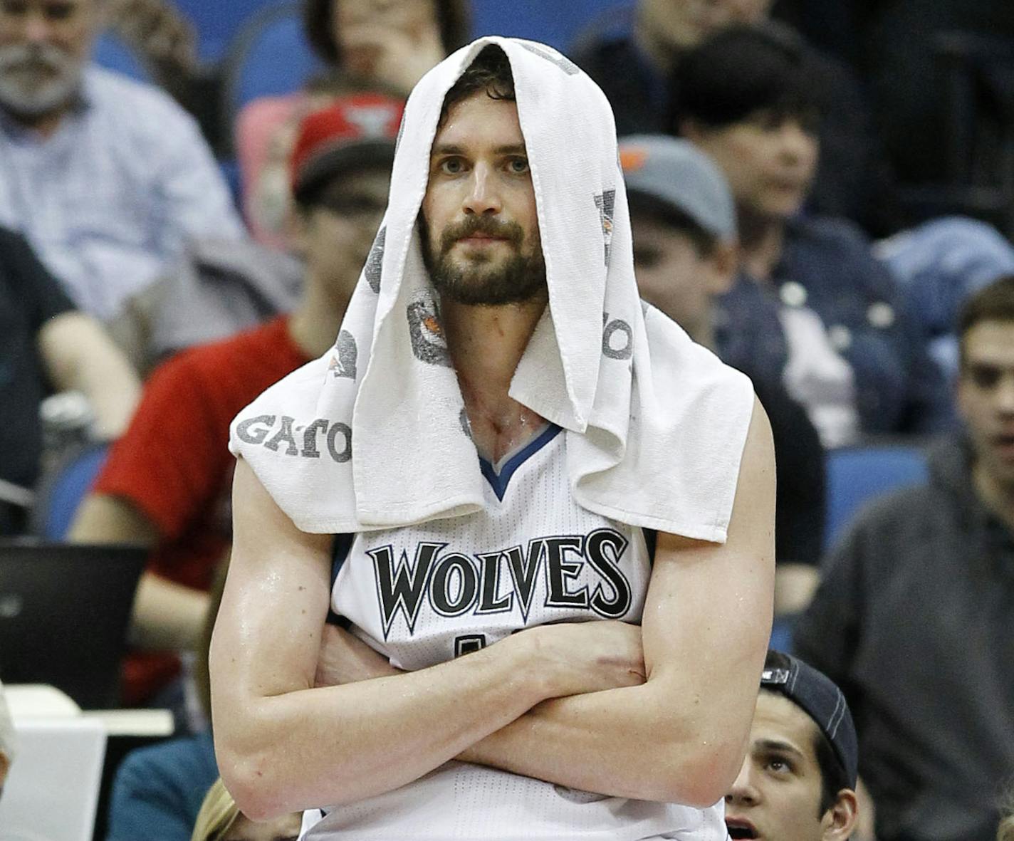 Minnesota Timberwolves forward Kevin Love sits on the advertisement stand during a timeout in the fourth quarter of the Timberwolves' NBA basketball game against the Chicago Bulls in Minneapolis, Wednesday, April 9, 2014.