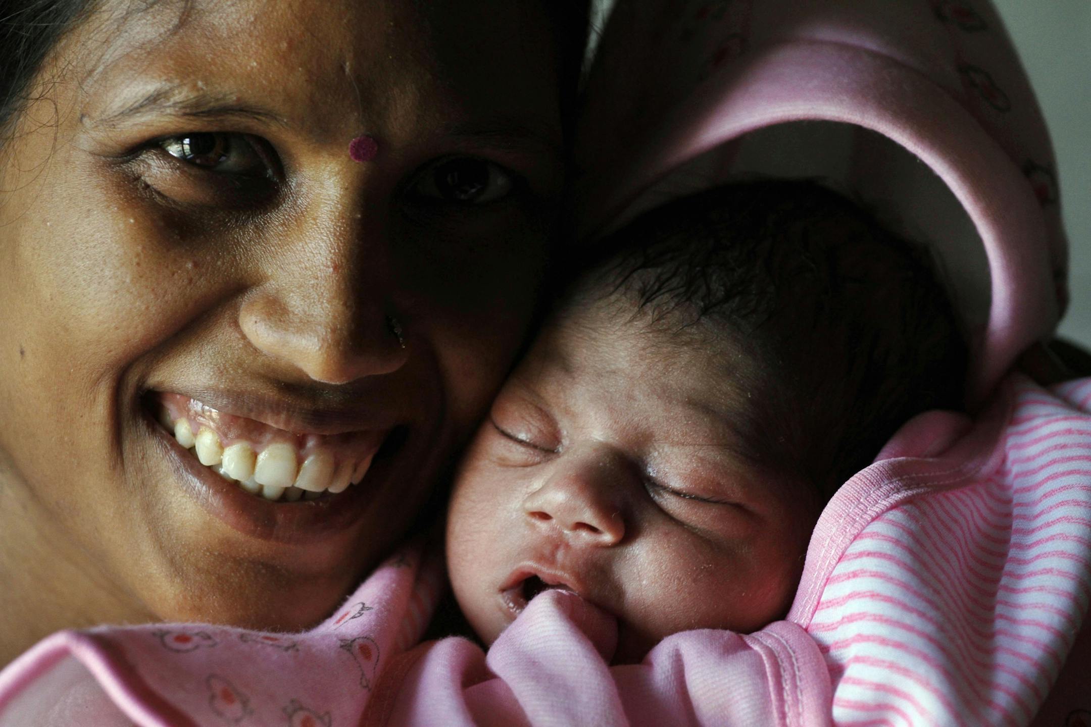 Mother Vinita, 23, carries her symbolic 7 billionth girl child, Nargis, at the Community Health Center in Mall, about 45 kilometers (28 miles) from Lucknow, India's most populous state of Uttar Pradesh, India, Monday, Oct. 31, 2011. According to the U.N. Population Fund, there will be symbolic "seven billionth" baby Earth's land and resources on Oct. 31. Already the second most populous country with 1.2 billion people, India is expected to overtake China around 2030 when its population soars to