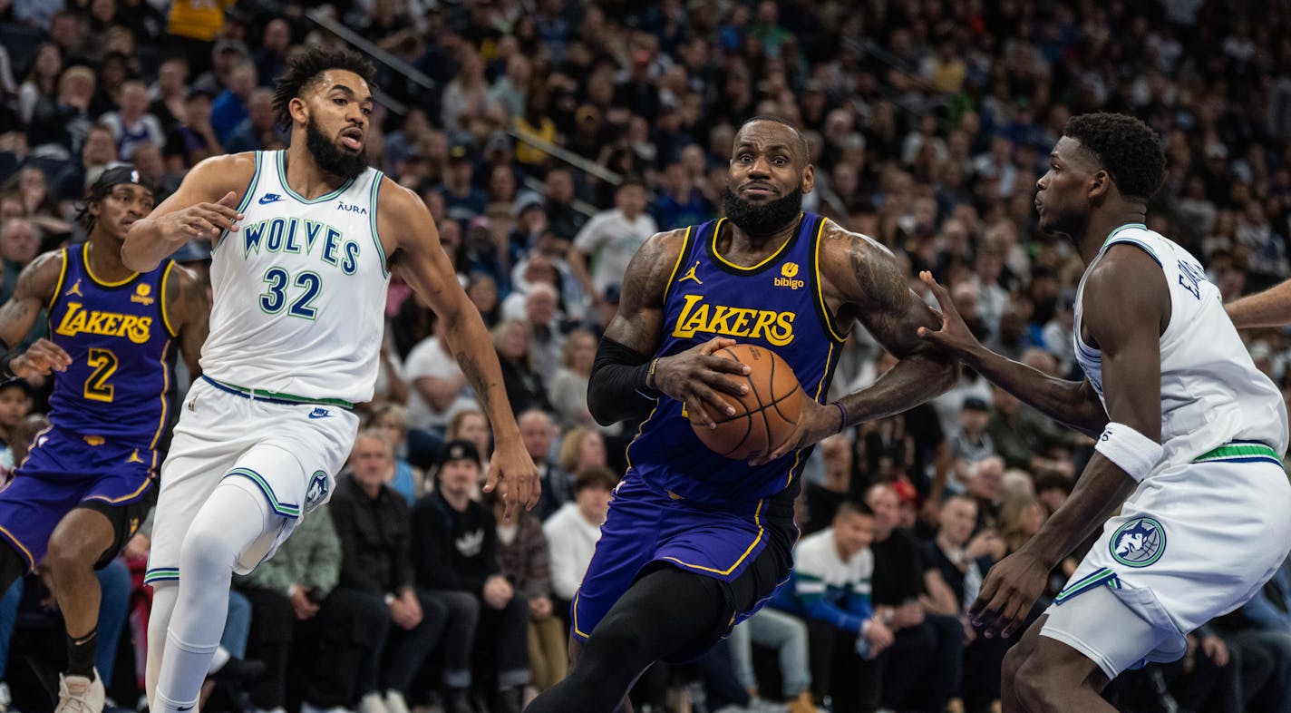 Los Angeles Lakers forward LeBron James (23) drove to the basket on Minnesota Timberwolves center Karl-Anthony Towns (32), and guard Anthony Edwards (5) in the fourth quarter Saturday December ,30, 2023 in, Minneapolis, Minn. ] JERRY HOLT • jerry.holt@startribune.com