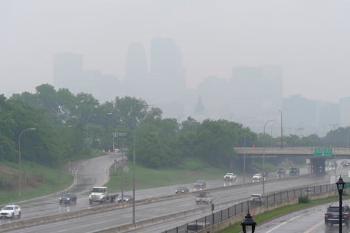 Smoke from wildfires burning in Canada and rain obscures the downtown skyline of Minneapolis on June 3.