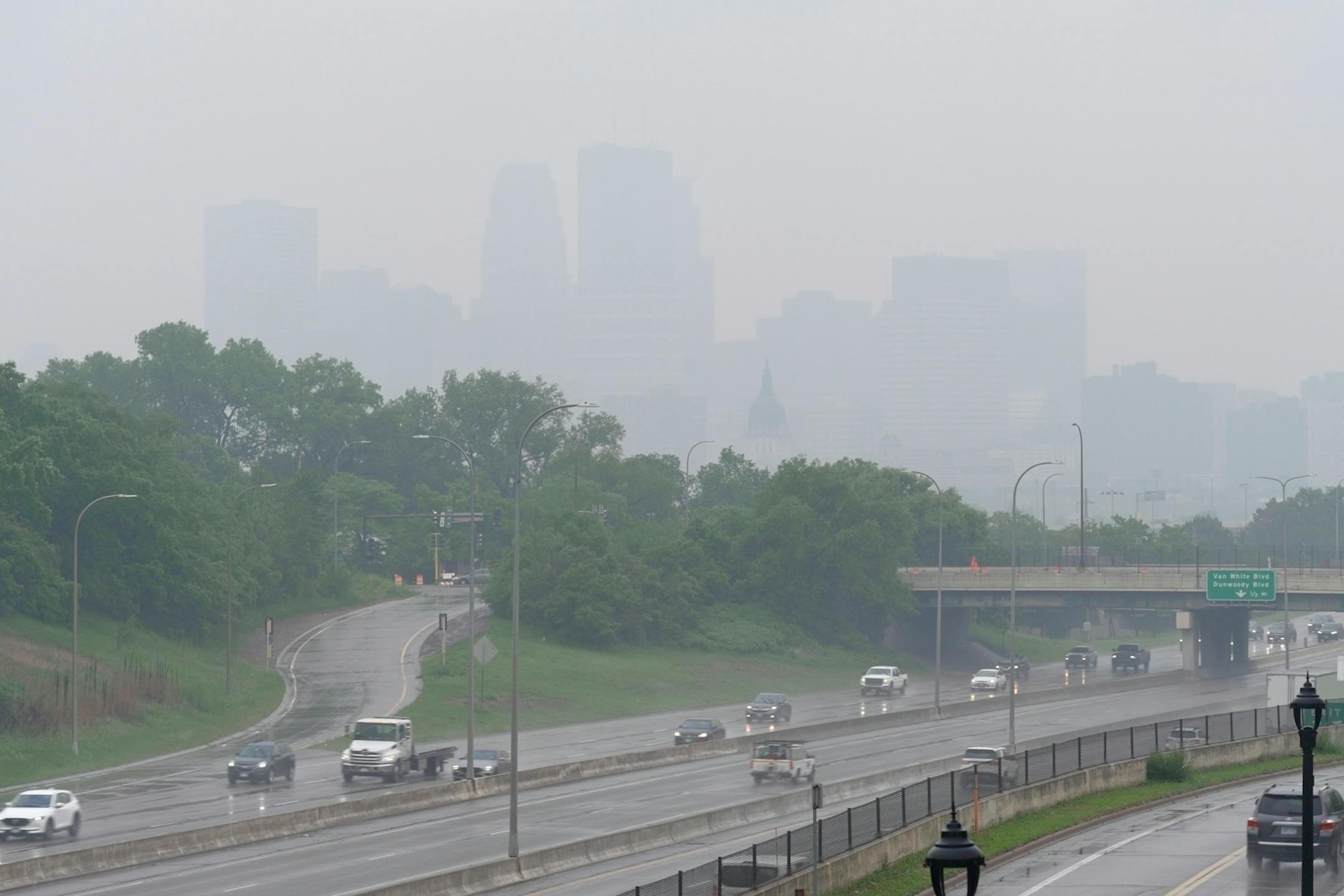 Smoke from wildfires burning in Canada and rain obscures the downtown skyline of Minneapolis on June 3.