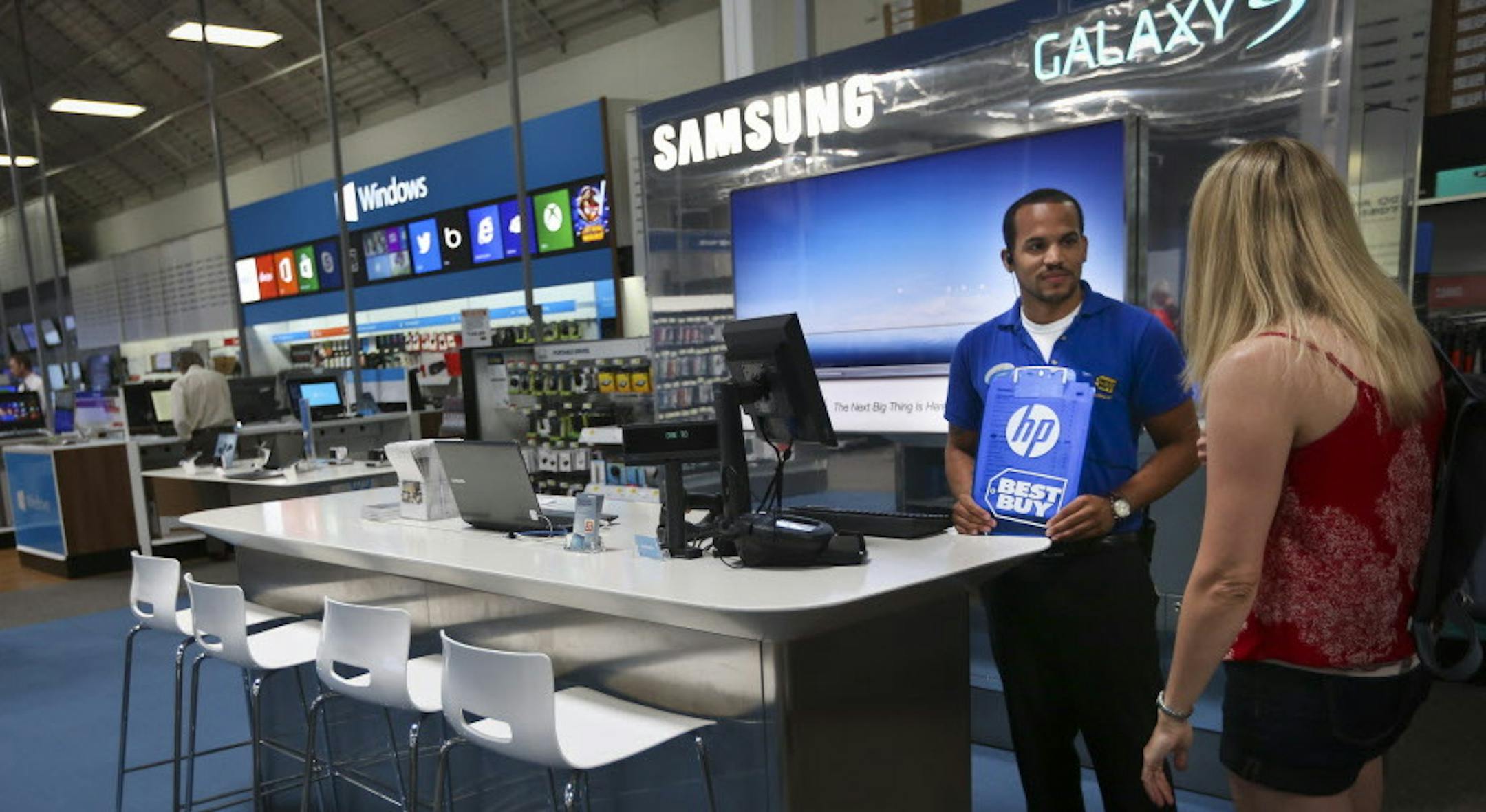 With its recent partnerships with Samsung and Microsoft, Best Buy has been one of the most aggressive proponent of the store within a store concept. Best Buy employee Phillip Stewart chatted with customer Karen Karpenko in the Samsung store in Best Buy in Richfield, Minn. on Wednesday, July 10, 2013. ] (RENEE JONES SCHNEIDER * reneejones@startribune.com)