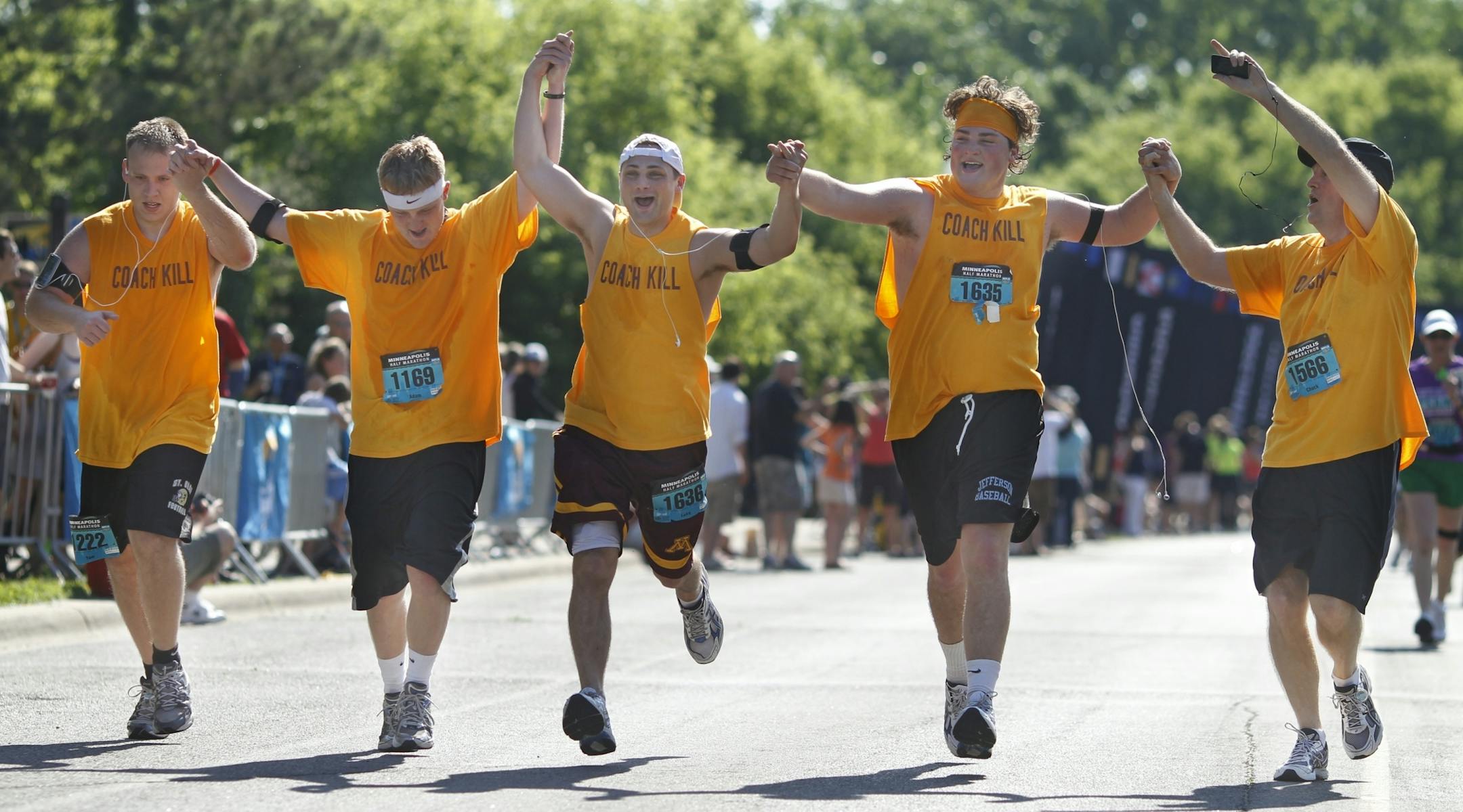 Running with "Coach Kill" T-shirts presumably in honor of new Gophers football coach Jerry Kill, half-marathoners (from left) Tom Starling, Adam Anderson, Luke Anderson, Joey Anderson, and Chuck Anderson celebrated as they approached the finish line of the Minneapolis Marathon on Saturday. Tom Tisell of St. Paul won for the third time in a row, finishing Sunday's race in 2 hours, 42 minutes, 26 seconds.