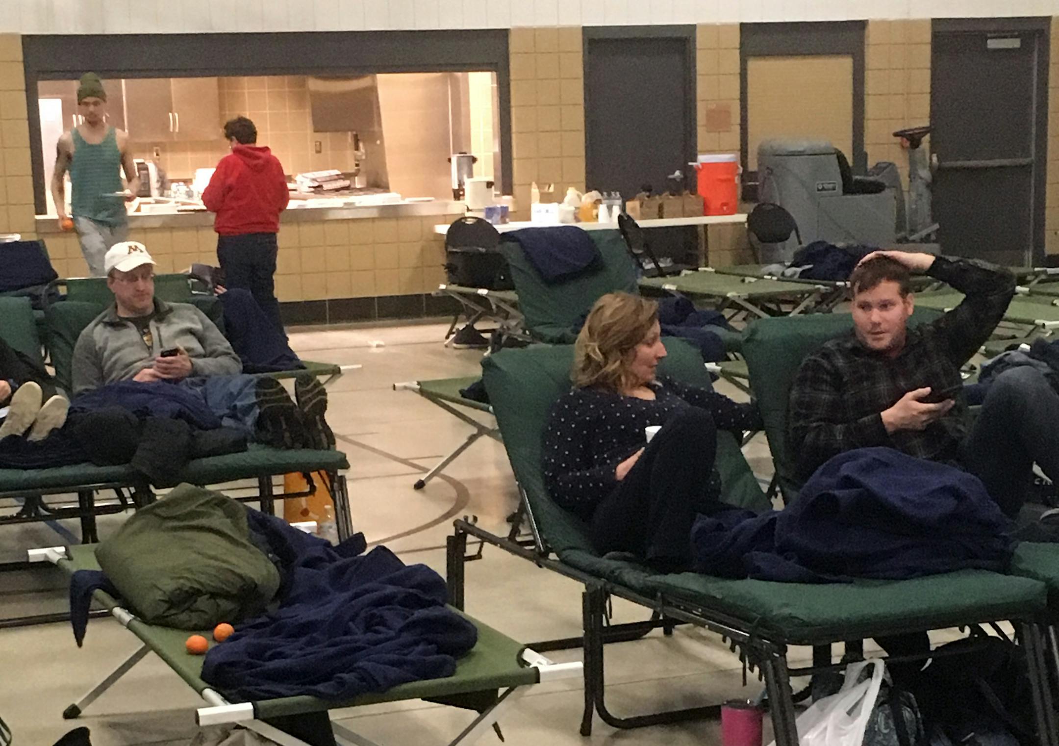 Dozens of travelers were still stranded Monday at the National Guard armory in Owatonna. Nate and Jessica Faue, right, were returning to Des Moines after a weekend trip to see the Minnesota Orchestra.