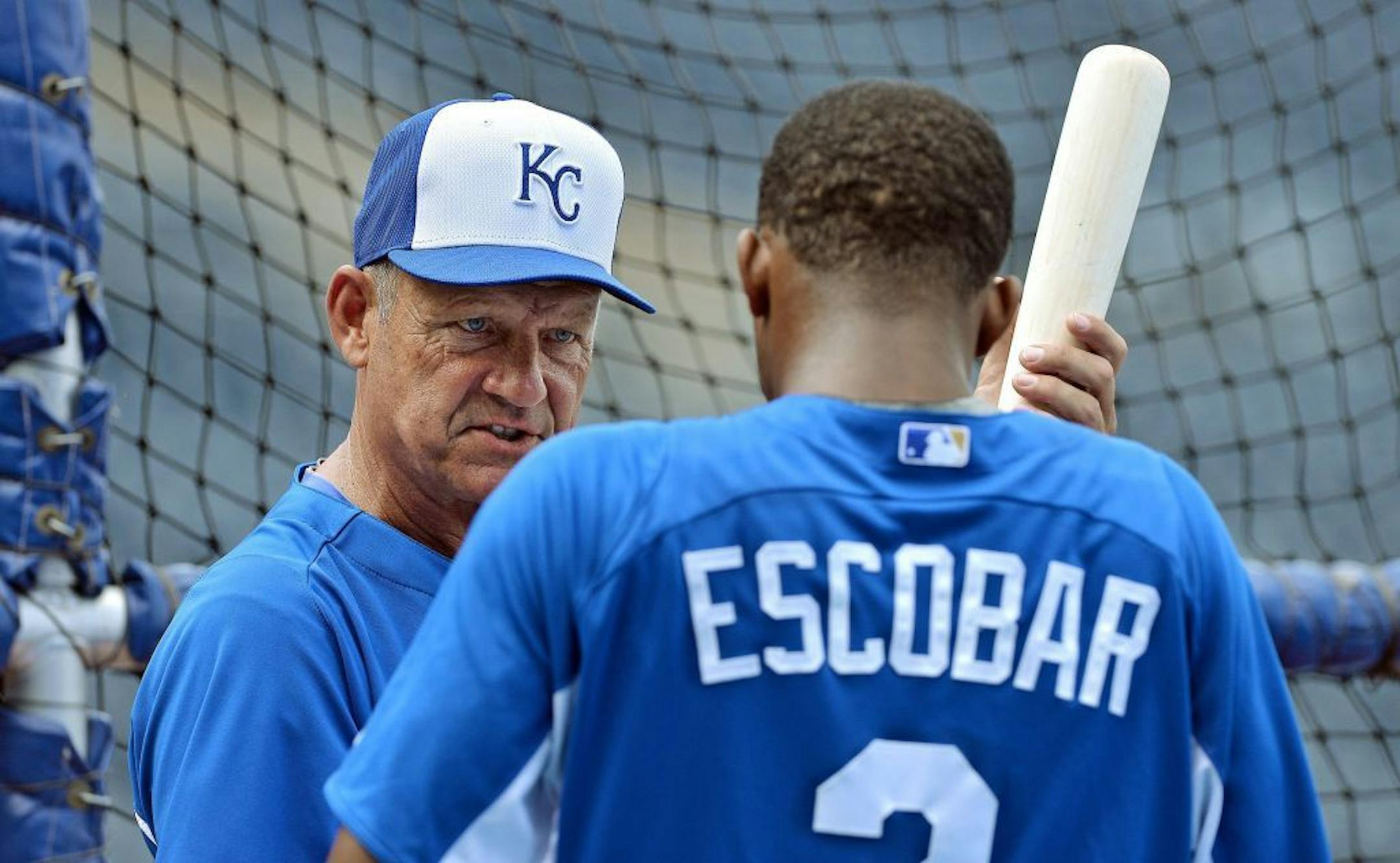 Kansas City Royals hitting coach George Brett talks with Alcides Escobar (2) at batting practice before play against the Minnesota Twins on Tuesday, June 4, 2013, at Kauffman Stadium in Kansas City, Missouri.