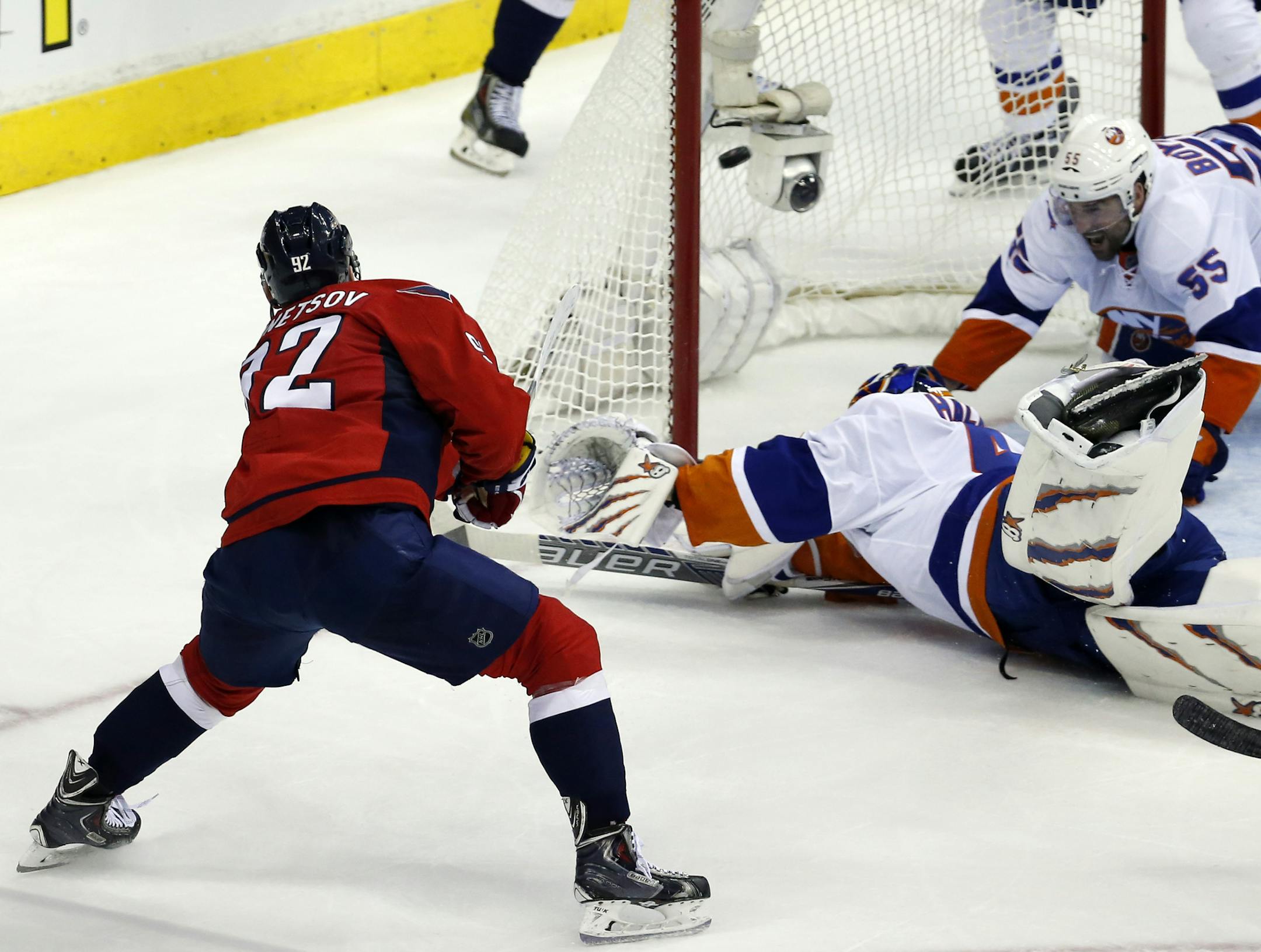Washington Capitals center Evgeny Kuznetsov (92), from Russia, shoots the game winning goal against New York Islanders goalie Jaroslav Halak (41), from the Czech Republic, and defenseman Johnny Boychuk (55) during the third period of Game 7 in the first round of the NHL hockey Stanley Cup playoffs, Monday, April 27, 2015, in Washington. The Capitals won 2-1, to advance. (AP Photo/Alex Brandon)