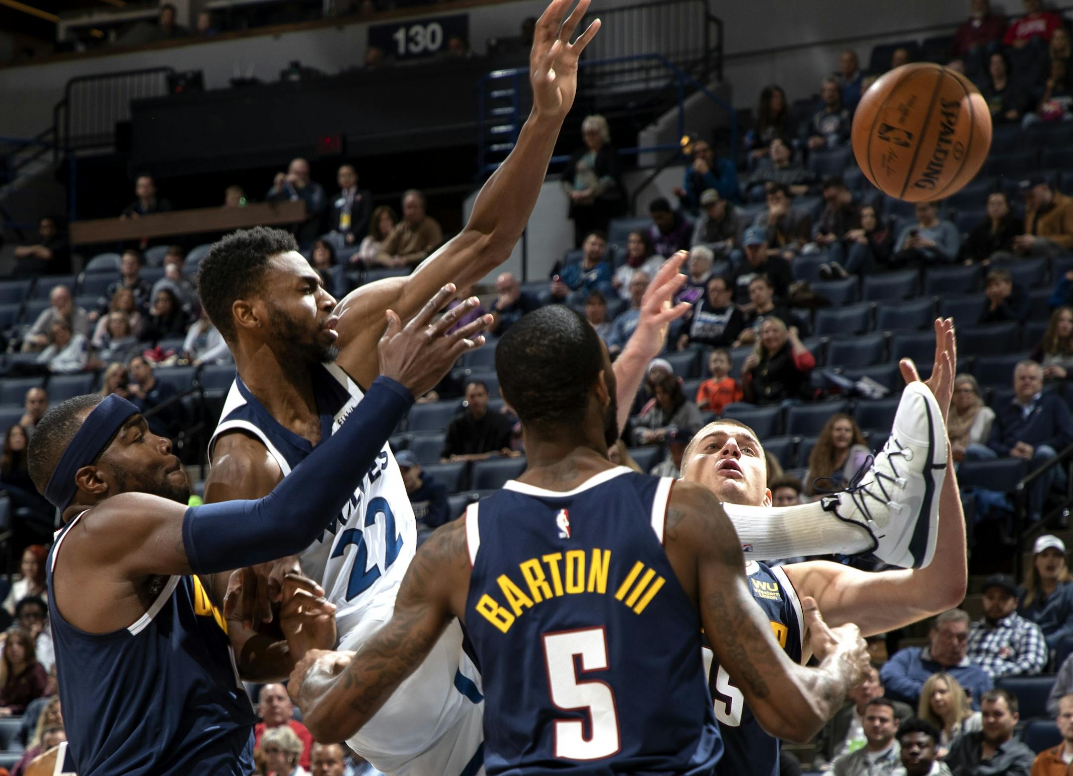 The Wolves' Andrew Wiggins (22) fought for the ball with Denver defenders in the second quarter.
