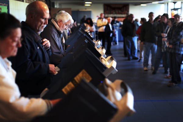 FILE-- Voters cast ballots at a polling station in Reedurban Presbyterian Church in Canton, Ohio, on Election Day Nov. 6, 2012. Low turnout early in t