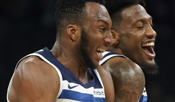 Minnesota Timberwolves forward Robert Covington (33) and Minnesota Timberwolves guard Josh Okogie (20) celebrated a sweet basket by Okogie in the seco