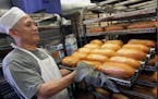 Owner Tony Le rolls out fresh bread from the huge ovens at the Trung Nam French Bakery, part of the Green Line tour.