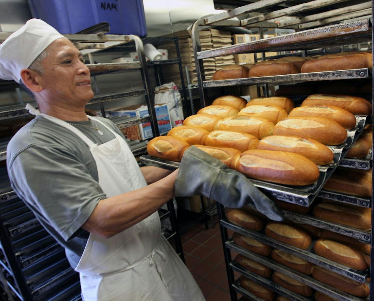 Owner Tony Le rolls out fresh bread from the huge ovens at the Trung Nam French Bakery, part of the Green Line tour.