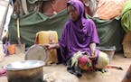 Somali young girl cooks food outside their makeshift home inside a refugee camp in Mogadishu, Somalia, Tuesday, Sept. 20, 2016. A new U.N. report says