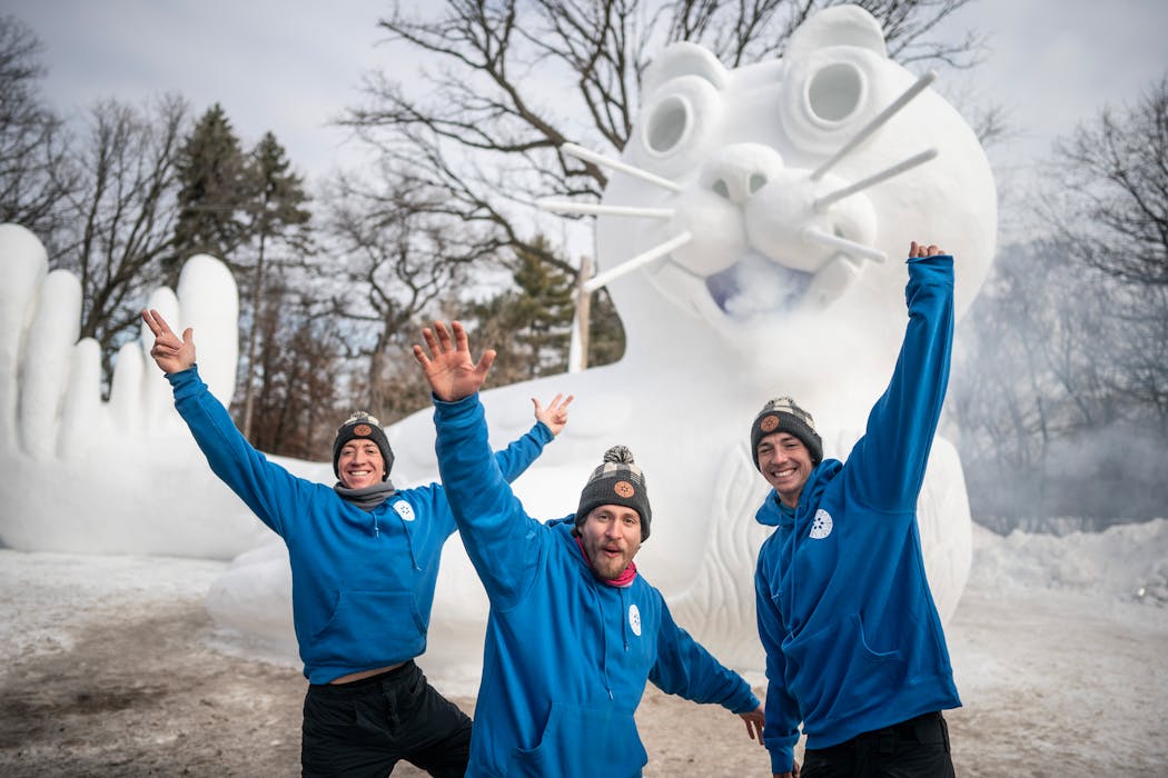 Austin Bartz, left, with friend Luke McCann and his brother Connor Bartz, pose for a picture by a 21 feet tall and 48 feet long, “Sparky the Seal,