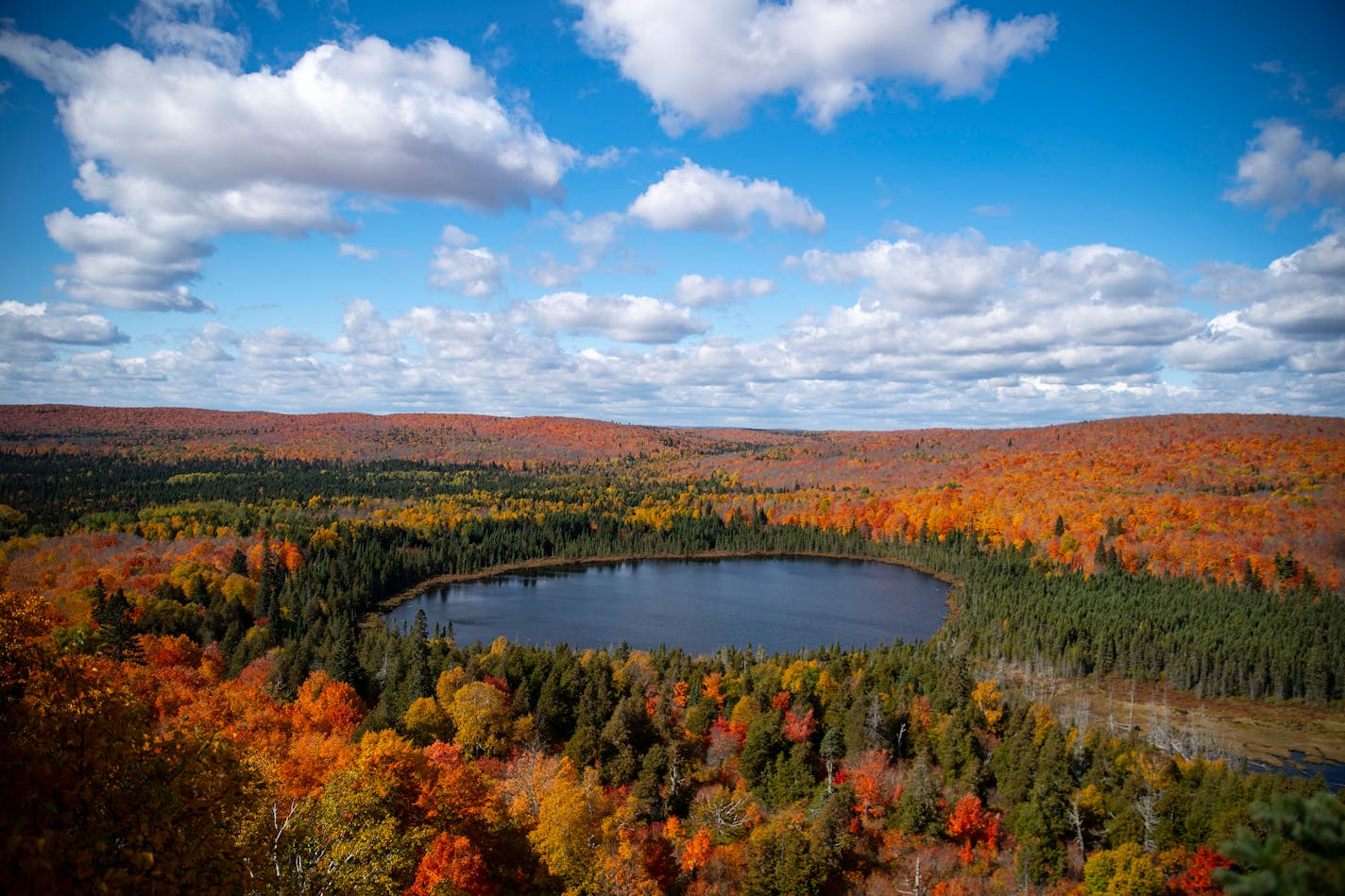 Fall foliage was peaking around Oberg Lake in Tofte, Minn. on Sunday.    ]