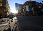 A cyclist rounded the corner onto Nicollet Mall across from Target. The Minneapolis Foundation’s strategy includes transforming Nicollet Mall to dra