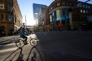 A cyclist rounded the corner onto Nicollet Mall across from Target. The Minneapolis Foundation’s strategy includes transforming Nicollet Mall to dra