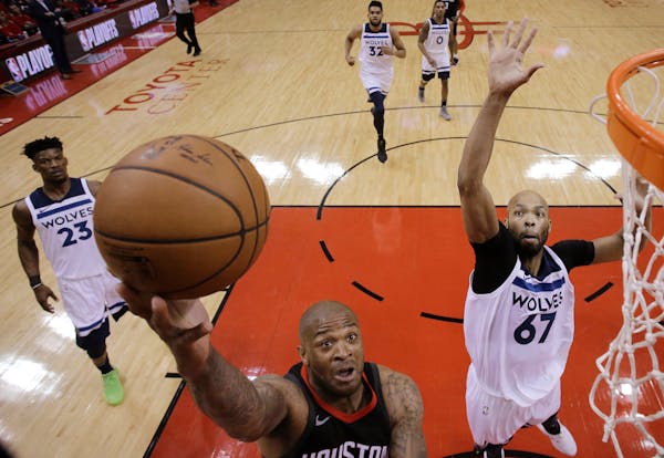 Rockets forward PJ Tucker, left, drives to the basket as Timberwolves forward Taj Gibsondefends during the first half of Game 5