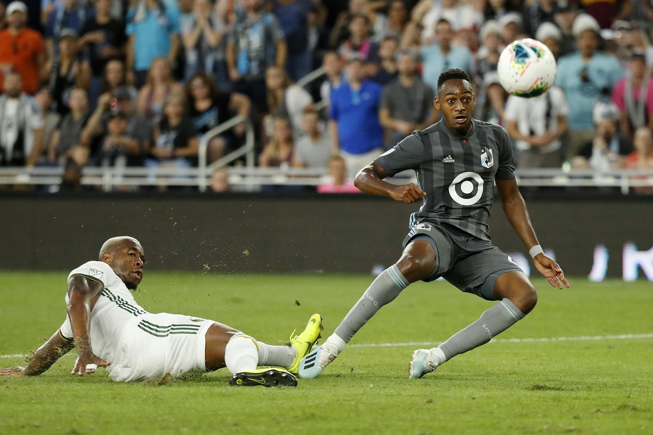 Minnesota United forward Mason Toye (23) scored a goal as Portland Timbers defender Claude Dielna (5) defended during the second half.