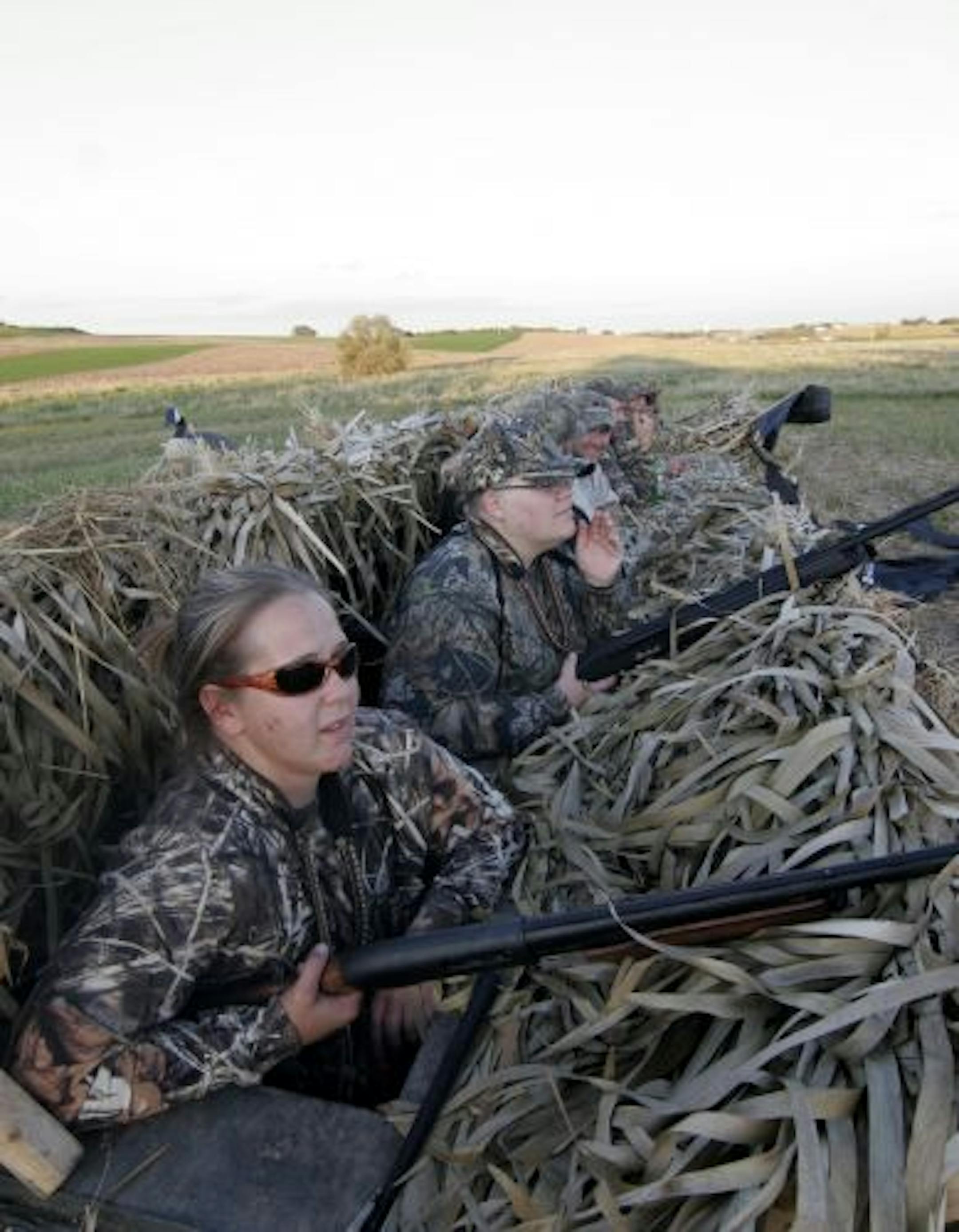 Megan Rhode and Alice Anderson of Burnsville scanned the sky for Canada geese late afternoon near Chaska during a women's goose hunt. With them were four male mentors and guides, and three other women hunters.