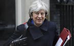 FILE - In this file photo dated Wednesday, Dec. 20, 2017, Britain's Prime Minister Theresa May leaves 10 Downing Street to attend at Parliament in Lon
