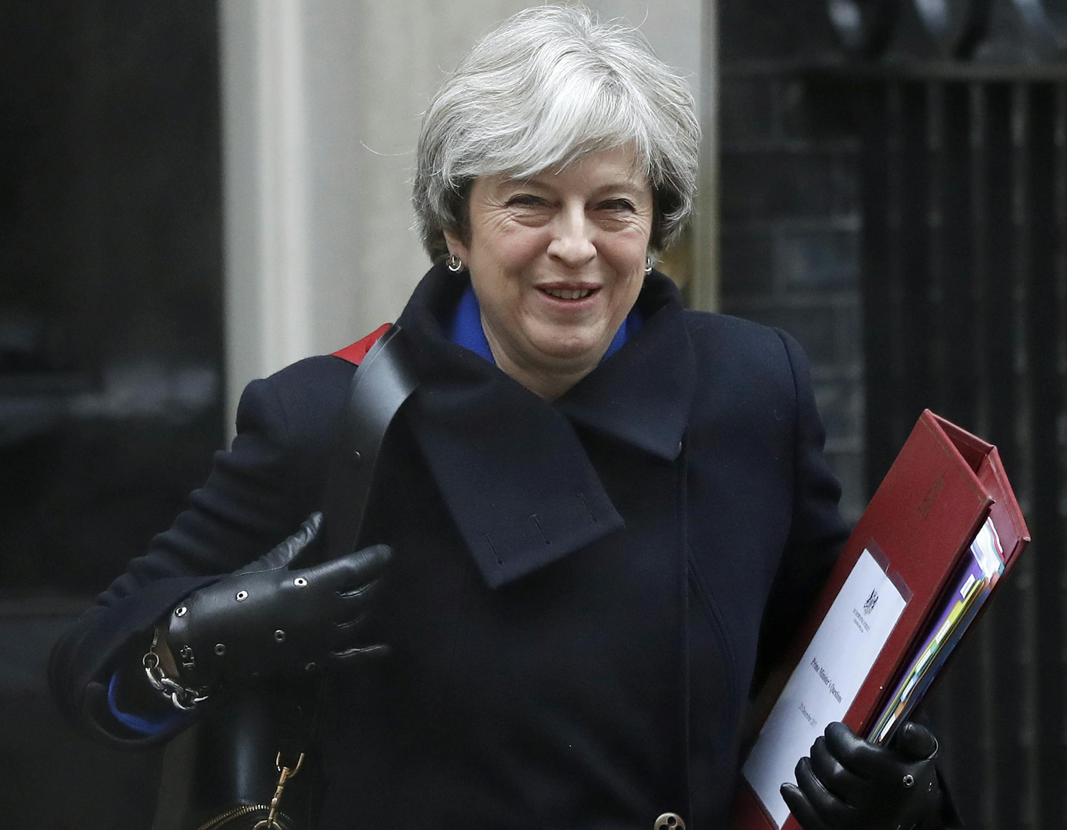 FILE - In this file photo dated Wednesday, Dec. 20, 2017, Britain's Prime Minister Theresa May leaves 10 Downing Street to attend at Parliament in London. Prime Minister May is reported Sunday Jan. 7, 2018, to have said she will re-jig the government ranks "soon," with the reshuffle of her Cabinet ahead of a crucial new phase in Brexit negotiations. (AP Photo/Kirsty Wigglesworth, FILE)
