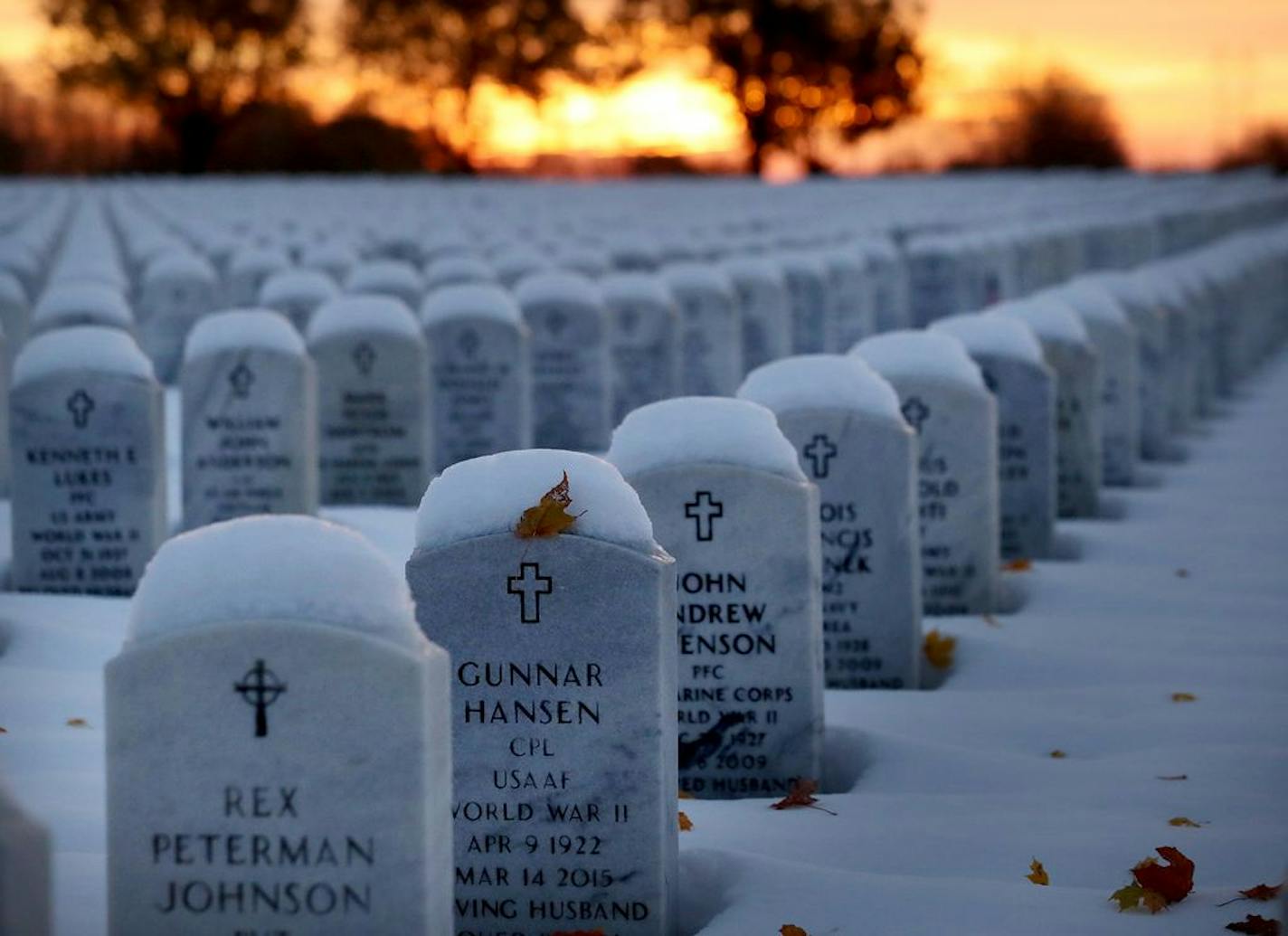 A fallen leaf was buried in fresh snowfall on a grave marker Wednesday morning at Fort Snelling National Cemetery.