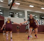 Sophie Hart, right, cheers on Gopher teammate Brynn Senden during a drill as they practiced at the Athletes Village in Minneapolis on Wednesday.