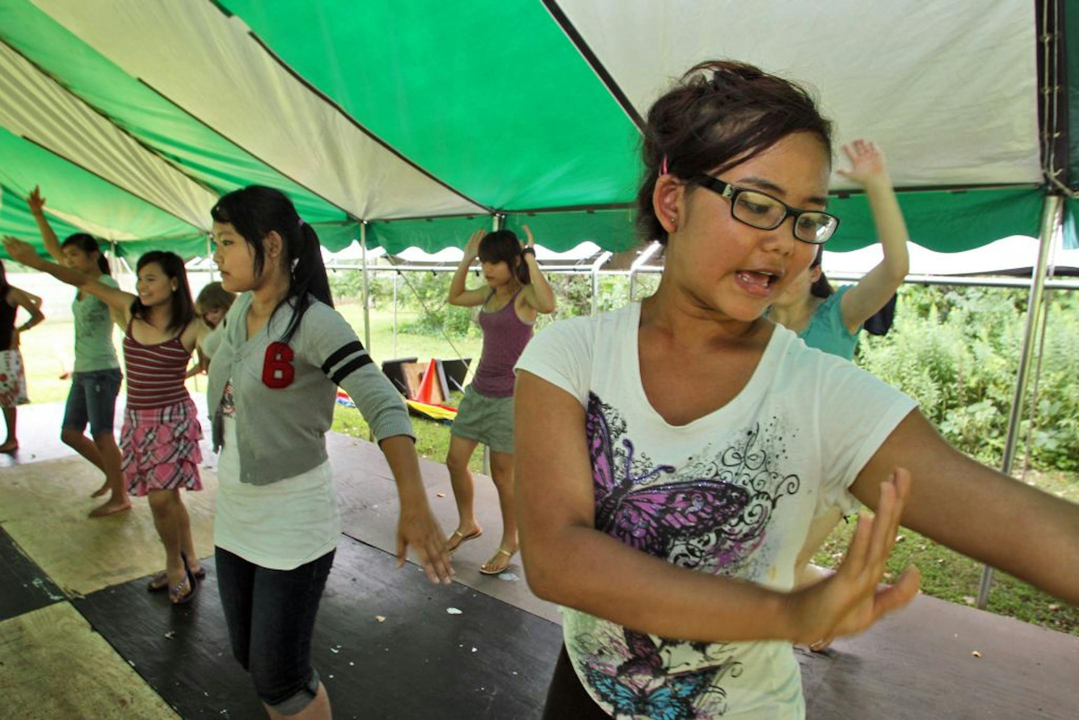 The Rosetown Playhouse's production of "Twist of Fate" brings together Roseville teens and youth refugees through the Karen Organization of Minnesota. A dress rehearsal of the play occurred recently at Villa Park in Roseville. Heny Htoo, 17, right, participated in a dance routine. (MARLIN LEVISON/STARTRIBUNE(mlevison@startribune.com