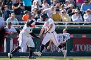 Twins minor league outfielder Dalton Shuffield celebrated his sixth-inning home run with third base coach Tommy Watkins against the Pirates on Saturda