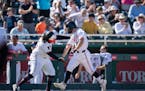 Twins minor league outfielder Dalton Shuffield celebrated his sixth-inning home run with third base coach Tommy Watkins against the Pirates on Saturda