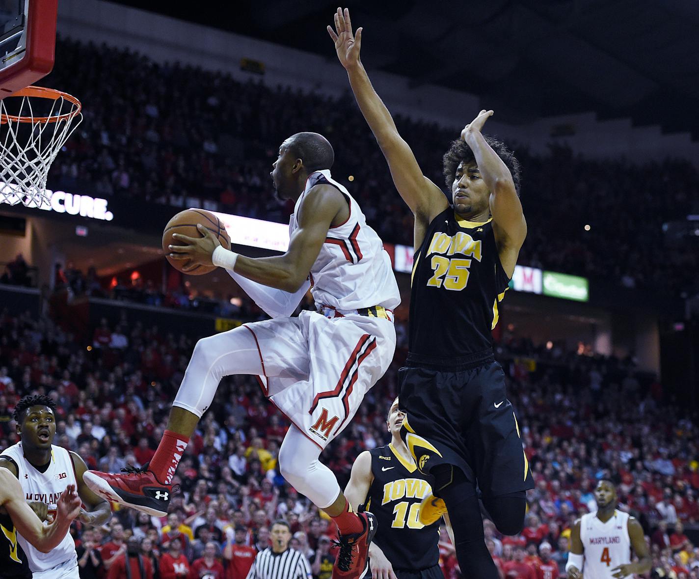 Maryland's Rasheed Sulaimon drives to the basket around Iowa's Dom Uhl in the second half of an NCAA college basketball game, Thursday, Jan. 28, 2016, in College Park, Md. Maryland won 74-68. (AP Photo/Gail Burton)