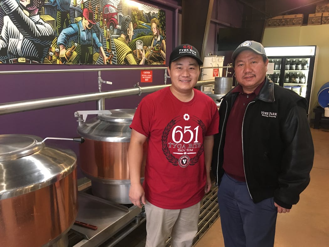 Jai Thor (left) and Touyer Moua are two of the owners of Vine Park Brewing. The St. Paul brewery is the first Hmong-owned brewery in the U.S.
