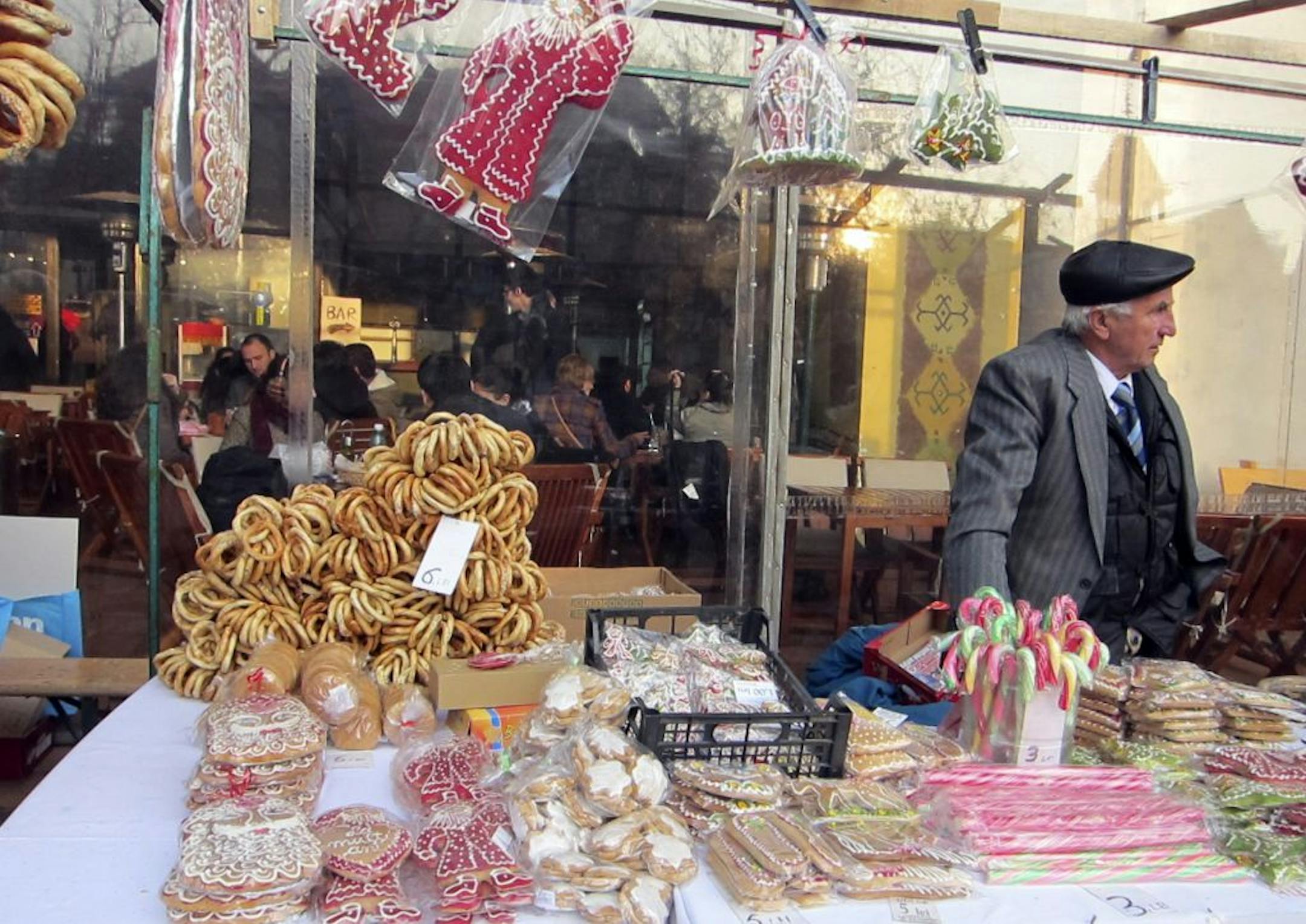 A merchant sells pretzels and gingerbread at an open-air farmers' market outside of the Museum of the Romanian Peasant along Kiseleff Boulevard in Bucharest.