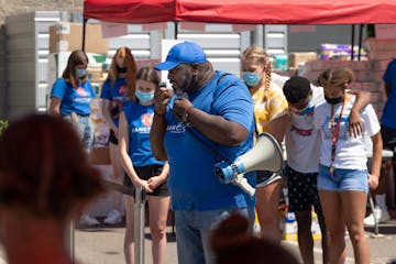 The Rev. Edrin Williams of Sanctuary Covenant Church in north Minneapolis led volunteers in prayer before opening the church's food distribution cente