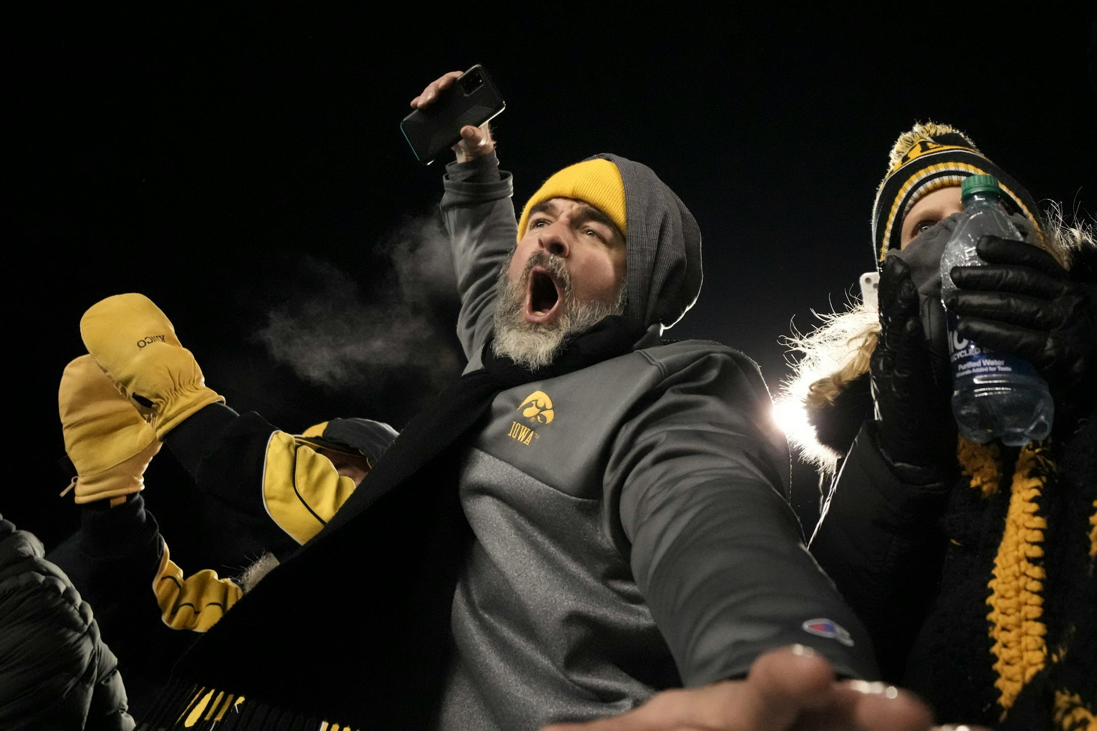 Iowa Hawkeyes fans celebrate after defeating the Minnesota Gophers 13-10 at Huntington Bank Stadium.
