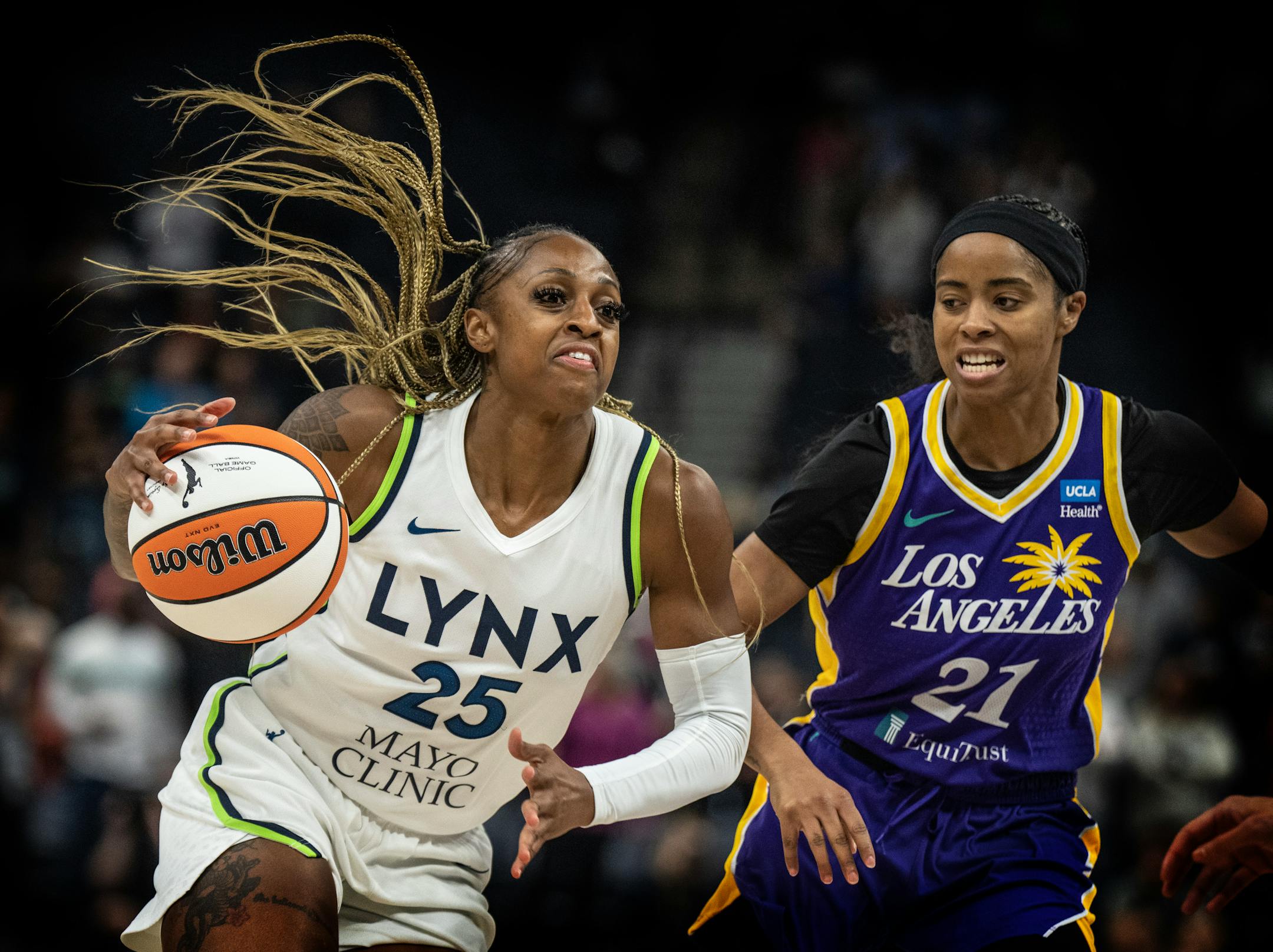Minnesota Lynx guard Tiffany Mitchell (25) drove to the basket on Los Angeles Sparks guard Jordin Canada (21) in the first half Sunday June 11,2023 in Minneapolis.